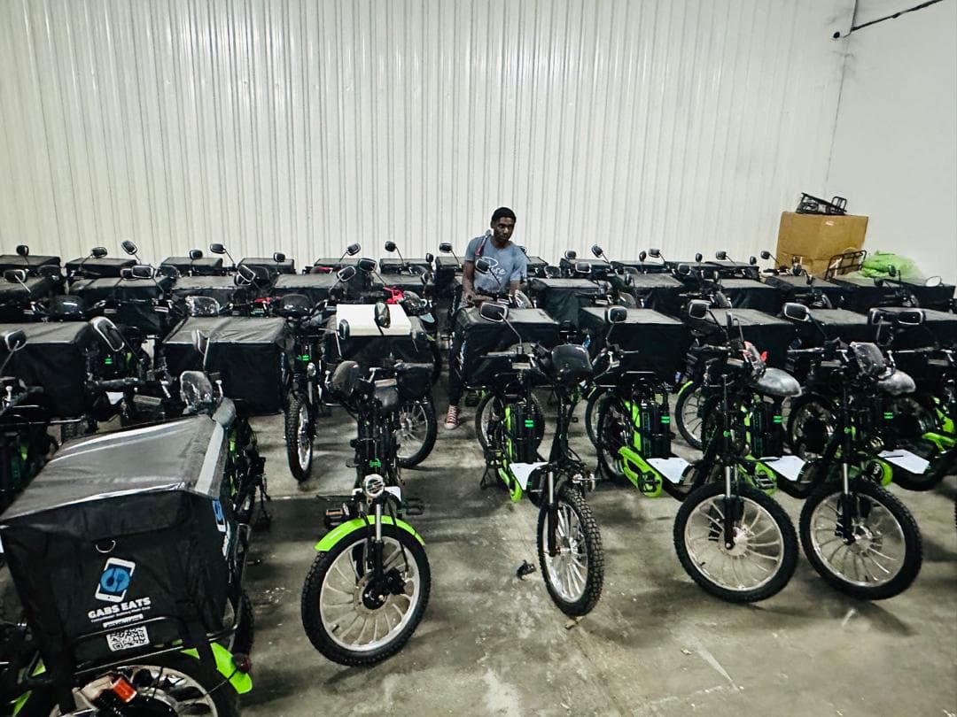 Rows of Gabs Eats electric delivery bikes at the fleet workshop