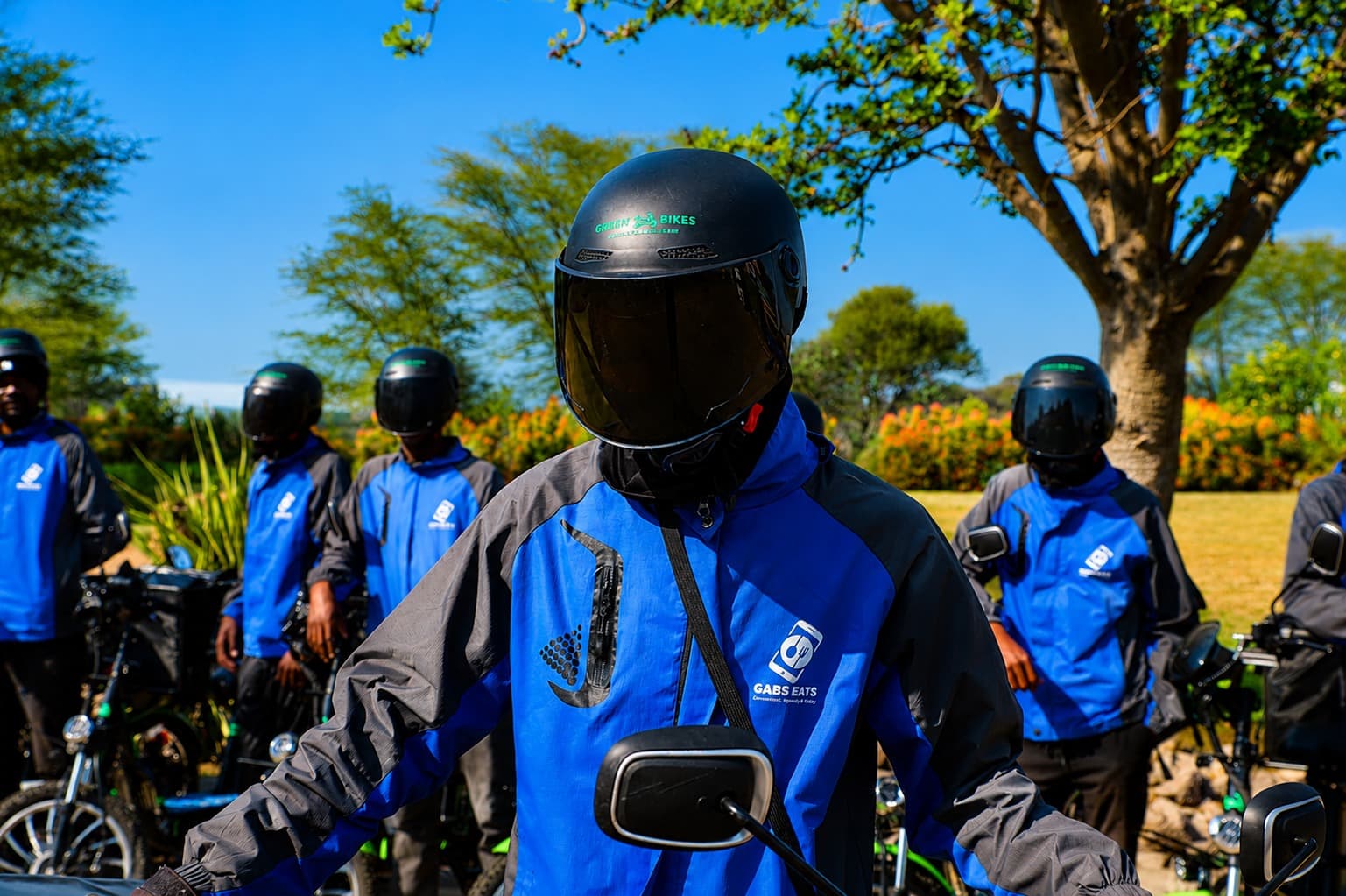 A Gabs Eats rider in full safety gear with the electric fleet