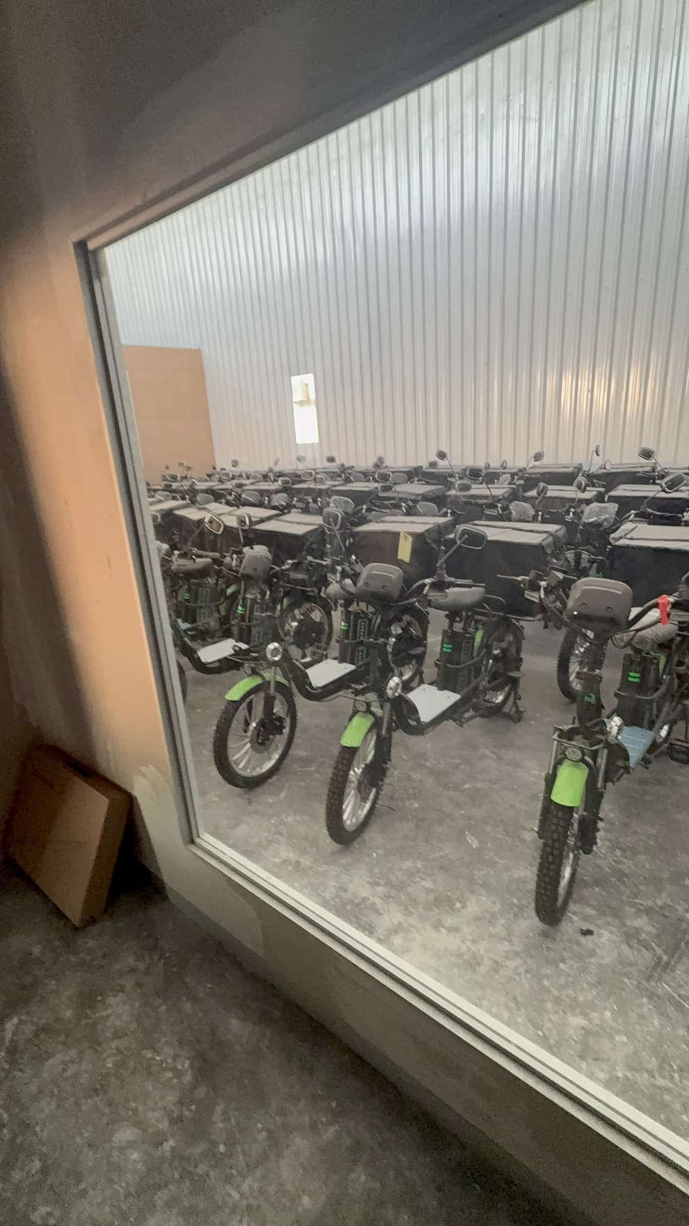 Rows of green electric delivery bikes